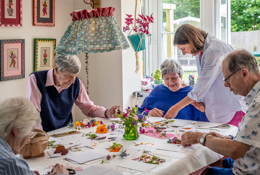 Tapestry Day Club dementia care host in Hastings and guests make flower cards