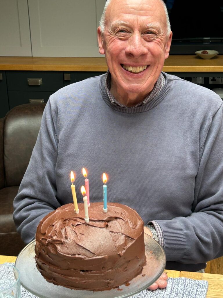 A guest receives birthday cake made by Tapestry Day Club dementia care Southwater host