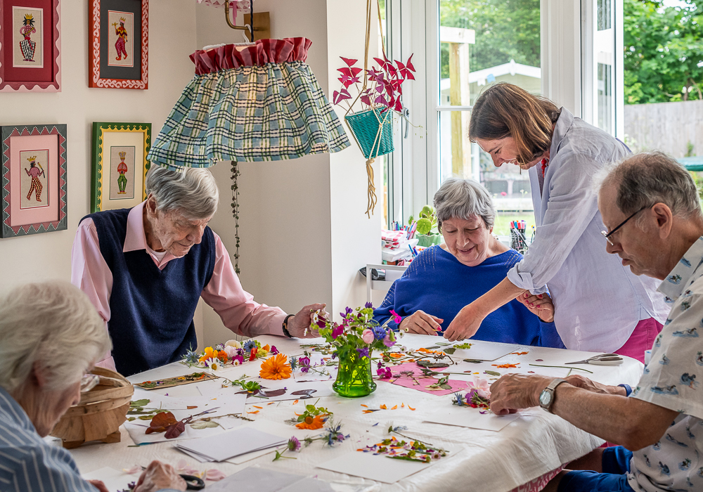 Tapestry Day Club dementia Day Care charity guest enjoy creating cards with flowers