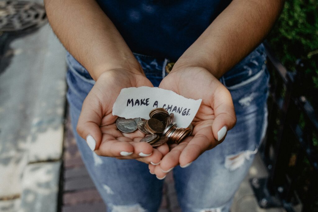 Hands containing coins with note saying 'make a difference' by fundraising for Tapestry Day Club dementia care